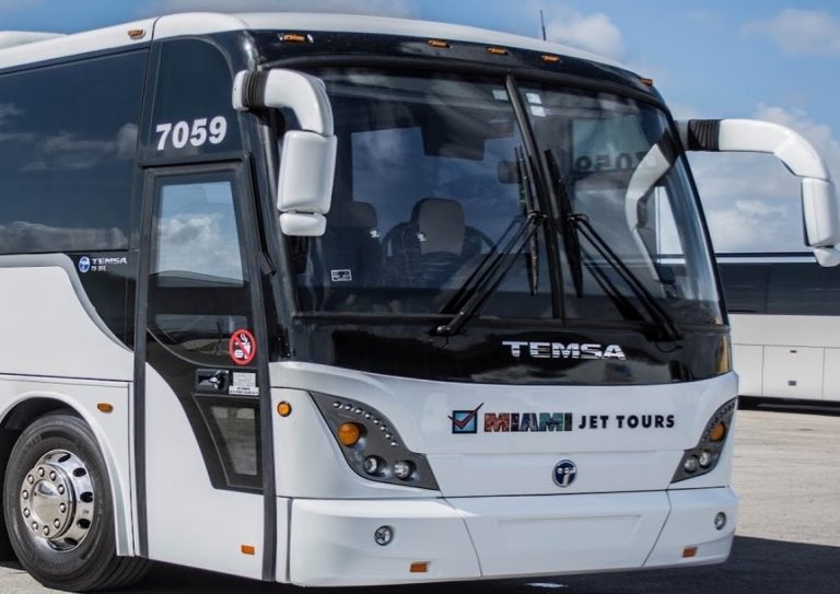 Front view of a white tour bus labeled "Miami Jet Tours" parked on a concrete surface, ready for its next adventure in the vehicle tracking story.