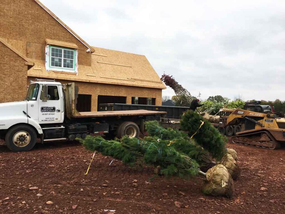 Meadow Services landscaping vehicle with GPS tracking on job site