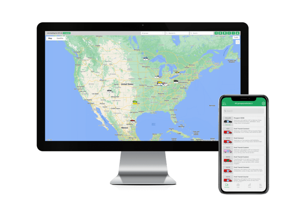 Computer monitor displaying a map of North America and a smartphone showing a list of vehicles on a green app interface.