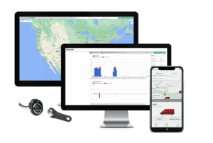 Fleet management software displayed on two computer monitors and a smartphone, showcasing graphs and maps alongside electric vehicle tracking data, next to a GPS tracking device.