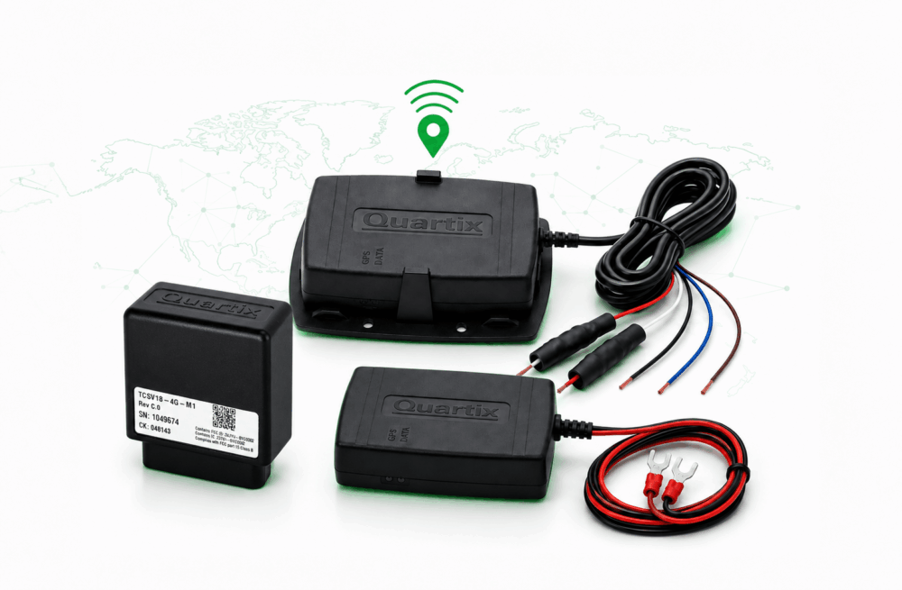 Four black Quartix GPS tracking devices with attached wires are displayed on a white surface, representing advanced GPS trackers for fleets, with a world map and a green wireless signal icon in the background.