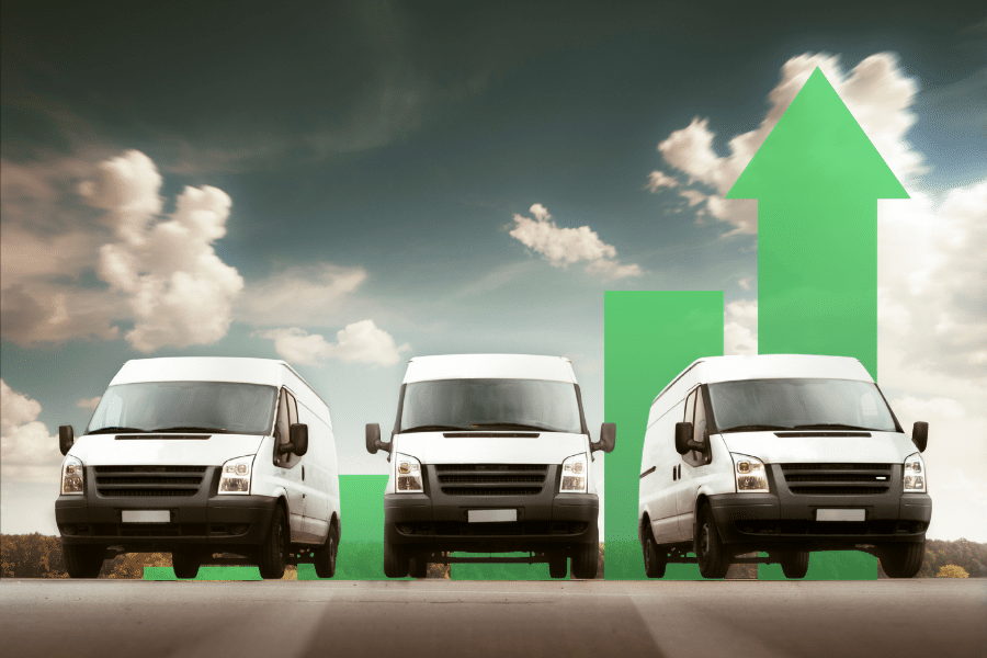 Three white delivery vans are parked in front of green upward-pointing arrow graphics, symbolising business growth or an increase in delivery demand under a partly cloudy sky—an inspiring scene for businesses with vehicles seeking to leverage Free Online Tools for greater efficiency.
