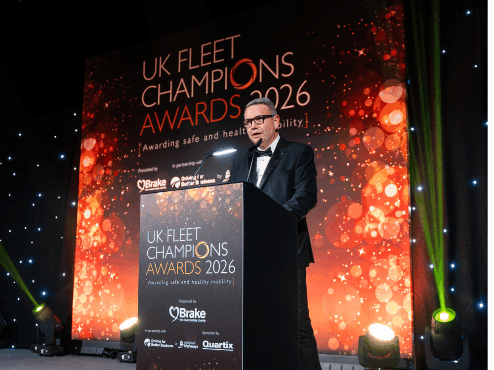 A man in a dinner jacket speaks at a lectern during the UK Fleet Champions Awards 2026.